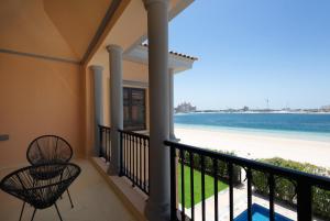 a balcony with a view of the beach at Maison Privee - Prvt Pool & Beach! in Luxury Palm Jumeirah Villa in Dubai