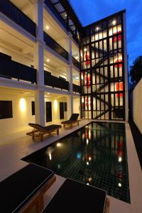 
a large room with a lot of windows in it at 99 The Gallery Hotel- SHA Extra Plus in Chiang Mai
