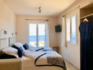 a bedroom with a bed and a window at Les Villas MarInCelu in Porto Pollo +118 photos