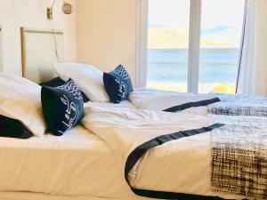 a bedroom with two beds with pillows and a window at Les Villas MarInCelu in Porto Pollo