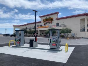 a gas station with two pumps in front of a building at Longstreet Inn & Casino in Amargosa Valley