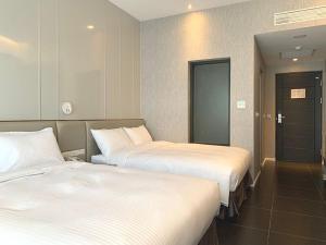 Postel nebo postele na pokoji v ubytování Champ De Rose Hotel