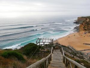 a stairway leading down to a beach with the ocean at The Surf Studio - Ericeira in Ericeira