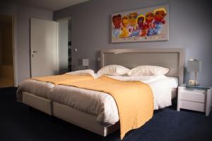 Ein Bett oder Betten in einem Zimmer der Unterkunft Het Maashotel
