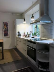 a kitchen with a sink and a stove top oven at ApartmentInCopenhagen Apartment 1316 in Copenhagen