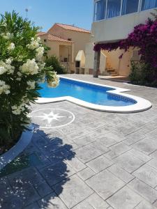 a swimming pool in front of a building at Seaside Villa in Calafat with Private Pool. in Calafat