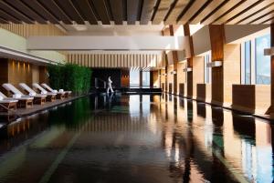 a hallway with a pool of water in a building at Park Hyatt Beijing in Beijing