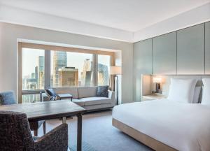 a hotel room with a bed and a couch at Park Hyatt Beijing in Beijing +63 photos