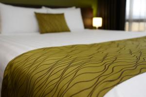 a close up of a bed with a brown blanket at Quest Rotorua Central in Rotorua