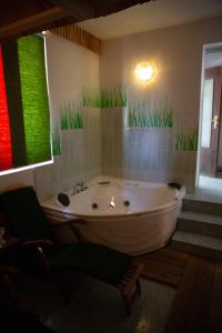 a bath tub in a bathroom with grass on the wall at Turistična Kmetija Zgornji Zavratnik in Luče