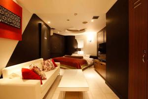 a hotel room with a couch and a bed at Hotel VARKIN in Tokyo