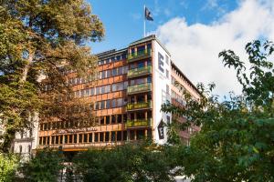 a tall building with a flag on top of it at Elite Eden Park Hotel in Stockholm