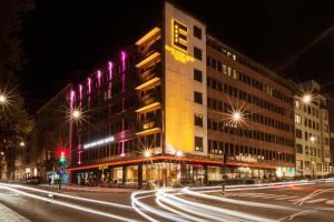 a building on a city street at night at Elite Eden Park Hotel in Stockholm +39 photos