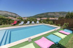 a swimming pool with chaise lounge chairs at Villa raffinée à Foix avec piscine privée et jacuzzi in Foix +15 photos