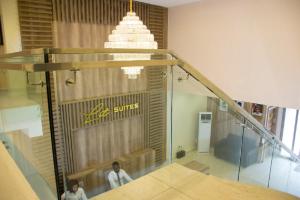 two people in a room with a glass staircase at Lit Suites in Abuja