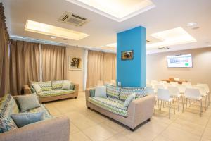 a waiting room with couches and chairs and a table at Wally Residence in Rimini