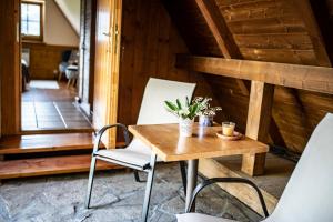 a wooden table and chairs in a room at Willa Leluja in Zakopane