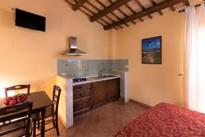 a kitchen with a sink and a table with a dining room at Casa Vacanze S. Marco in Valderice