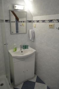 a white bathroom with a sink and a mirror at Intertranscoop Lake House in Vámosszabadi +46 photos