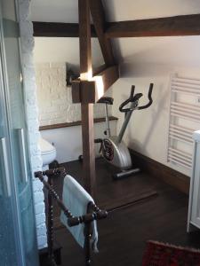 een fitnessruimte met een loopband en een hometrainer bij Les Remparts in Binche