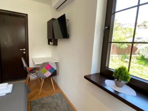 a living room with a chair and a window at My Grandparents House in Ohrid