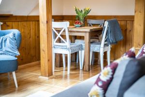 a dining room with a wooden table and chairs at Willa Leluja in Zakopane