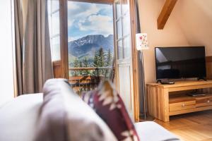 a living room with a couch and a large window at Willa Leluja in Zakopane