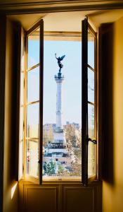 a window view of a statue in front of a monument at Les Folies de Chauvin in Bordeaux