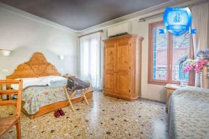 a bedroom with a large bed and a window at B&b Allegri in Venice