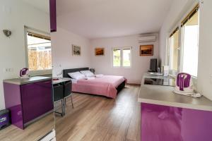 two pictures of a room with a bed and a kitchen at Dida Boža House in Vodice