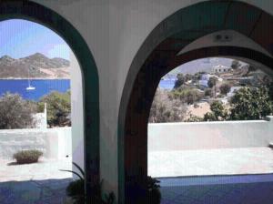 an archway in a building with a view of the ocean at Apolafsis Studios in Patmos