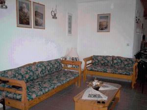a living room with two couches and a coffee table at Apolafsis Studios in Patmos