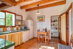 a kitchen with a table and a refrigerator at Villa Vertent in Alcudia