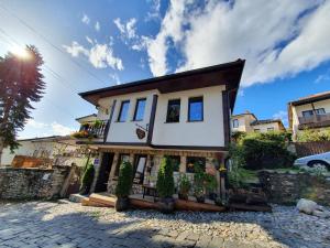 a small white house on a cobblestone street at My Grandparents House in Ohrid