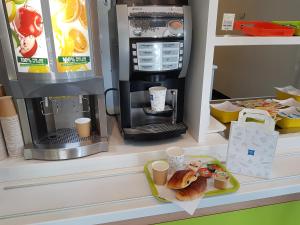 a toy kitchen with a coffee maker and a plate of food at Ibis Budget Marseille Valentine in Marseille