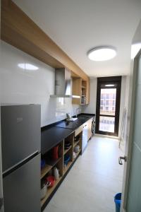 una cucina con lavandino e piano di lavoro di Apartamentos Gran Socaire de Noja a Noja