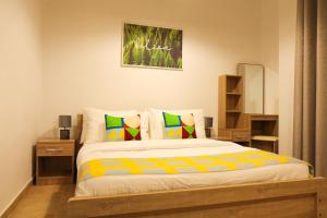 a bedroom with a large bed with colorful pillows at SHH - Furnished Studio in Silicon Gates 1, Silicon Oasis in Dubai