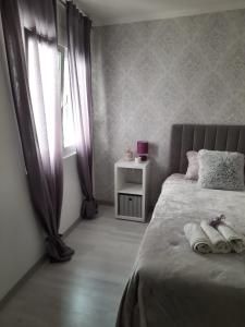 a bedroom with a bed with two towels on it at Studio AJDY in Mostar