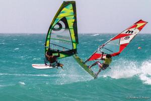 two people are windsurfing in the ocean at Hostels Holiday Cape Verde in Santa Maria