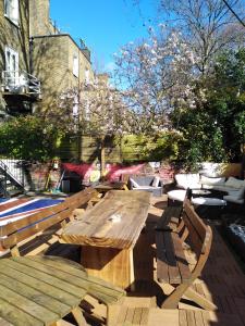 a wooden bench sitting on top of a wooden deck at Saint James Backpackers in London