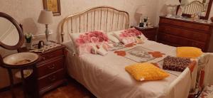 a bedroom with a bed with flowers on it at Casa Miramonti in Perosa Argentina