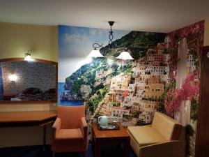 a room with a wall mural of a city at Family Hotel Vaso in Varna City