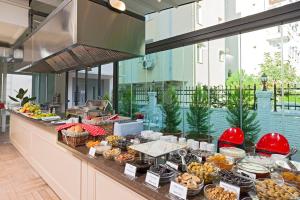 a buffet of food on a counter in a building at The Room Hotel & Apartments in Antalya