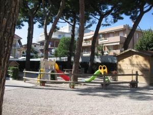 a park with a playground with a slide and scissors at Residence Dolce Vita in San Benedetto del Tronto