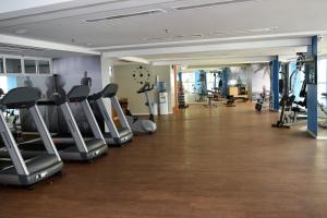 a gym with treadmills and ellipticals in a room at Grupo Vip Beach Class Fortaleza in Fortaleza