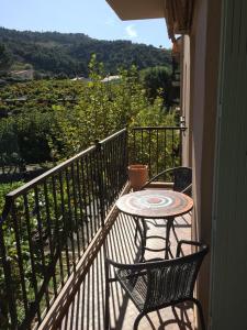 a table and chairs on a balcony with a view at Apartment Olive & Kin, Collioure in Collioure