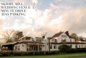 a white house with the words publicly will wedding venue ismitmit at 52 Minster in Beverley