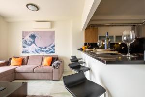 a living room with a couch and a kitchen at Fábrica da Ribeira 53 by Destination Algarve in Lagos