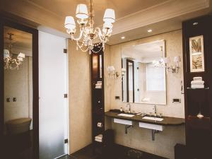 a bathroom with two sinks and a chandelier at Palacio Duhau - Park Hyatt Buenos Aires in Buenos Aires