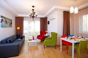 a living room with a couch and a table and chairs at The Room Hotel & Apartments in Antalya